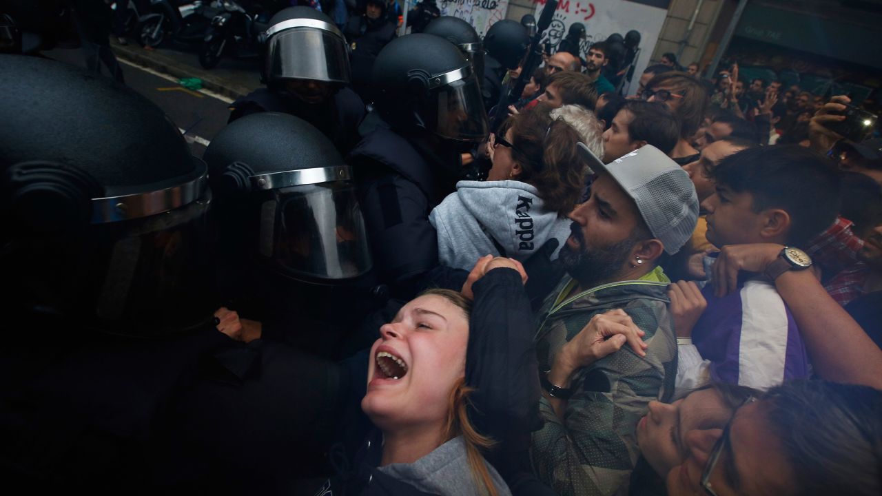 A girls grimaces as Spanish National Police pushes away Pro-referendum supporters outside the Ramon Llull school assigned to be a polling station by the Catalan government in Barcelona, Spain, early October 1.