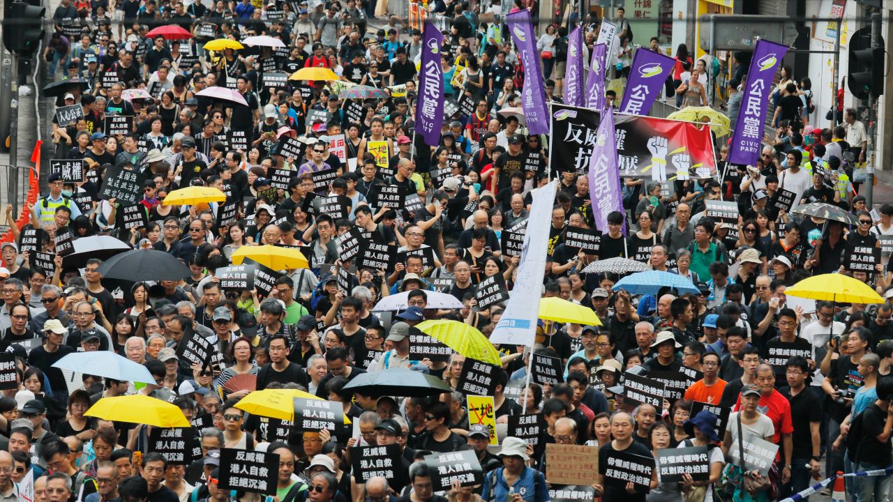 Protesters march in Hong Kong on Sunday, October 1, 2017.