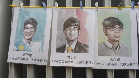 Portraits of three jailed Hong Kong pro-democracy activists -- Nathan Law, Alex Chow and Joshua Wong -- seen at a protest march on October 1, 2017. 