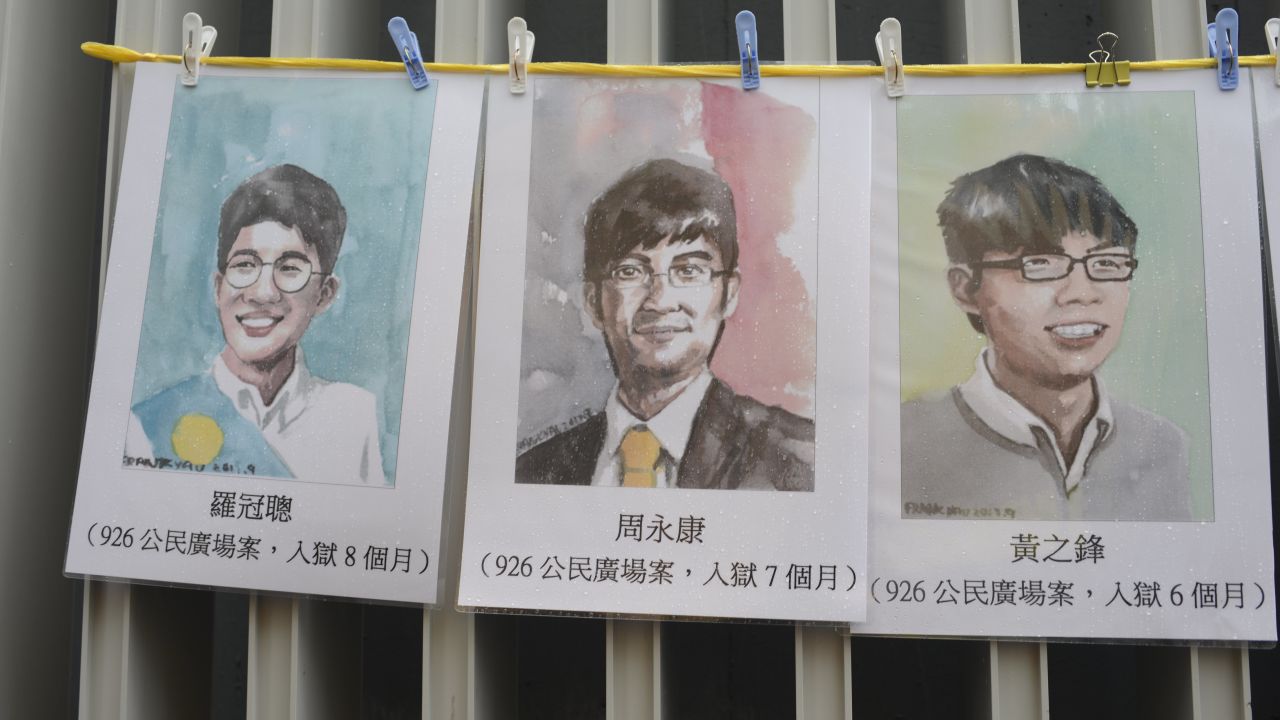 Portraits of three jailed Hong Kong pro-democracy activists -- Nathan Law, Alex Chow and Joshua Wong -- seen at a protest march on October 1, 2017.