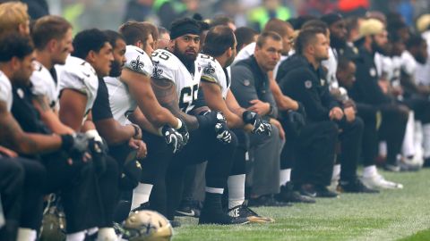 New Orleans Saints players and team kneel prior to the NFL match against Miami Dolphins at Wembley Stadium.