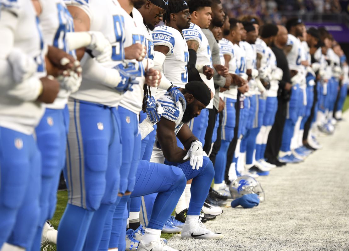 Steve Longa, a linebacker with the Detroit Lions, takes a knee with teammate Jalen Reeves-Maybin during the National Anthem before playing the Minnesota Vikings in Minneapolis, Minnesota. 