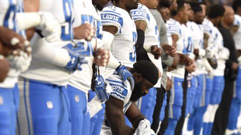  Steve Longa of the Detroit Lions takes a knee with teammate Jalen Reeves-Maybin during the national anthem before the game against the Minnesota Vikings.