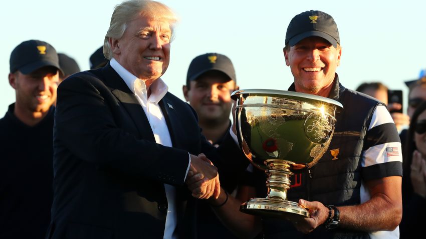 President Donald Trump presents Captain Steve Stricker and the US Team with the trophy after they defeated the International Team in the Presidents Cup at Liberty National Golf Club on Sunday in Jersey City, New Jersey.