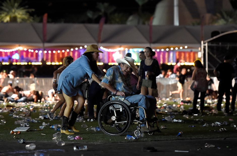A man in a wheelchair is evacuated from the festival after gunfire was heard.