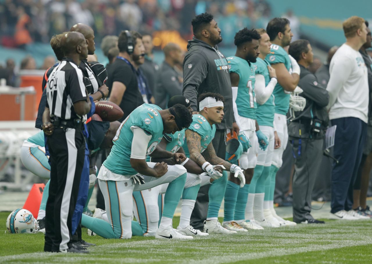 Miami Dolphins players kneel during the National Anthem before playing the New Orleans Saints at Wembley Stadium on October 1 in London.