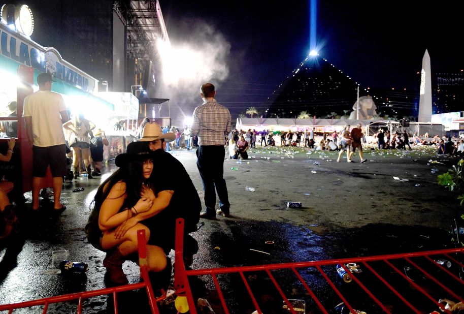A couple huddles after shots rang out at a country music festival on the Las Vegas Strip on Sunday, October 1, 2017. At least 58 people were killed and almost 500 were injured when <a href="http://www.cnn.com/2017/10/02/us/las-vegas-shooter/index.html" target="_blank">a gunman opened fire</a> on the crowd. Police said the gunman, 64-year-old Stephen Paddock, fired from the Mandalay Bay hotel, several hundred feet southwest of the concert grounds. He was found dead in his hotel room, and authorities believe he killed himself and that he acted alone. It is the deadliest mass shooting in modern US history.