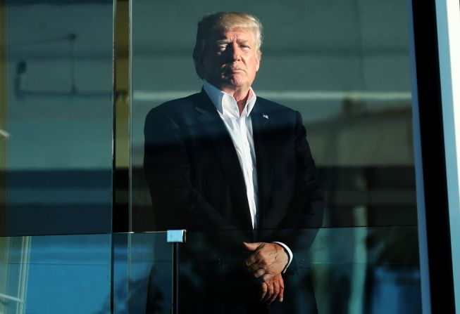 Trump, who is a keen golfer, watches the action from the clubhouse at Liberty National Golf Club.