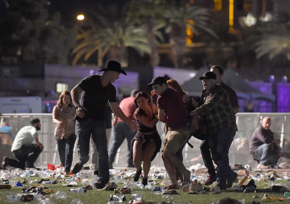 Concertgoers help an injured person at the scene of a mass shooting in Las Vegas.