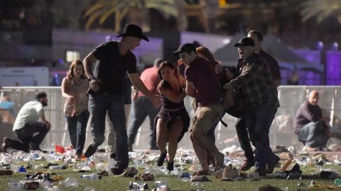 Concertgoers help an injured person at the scene of a mass shooting in Las Vegas.