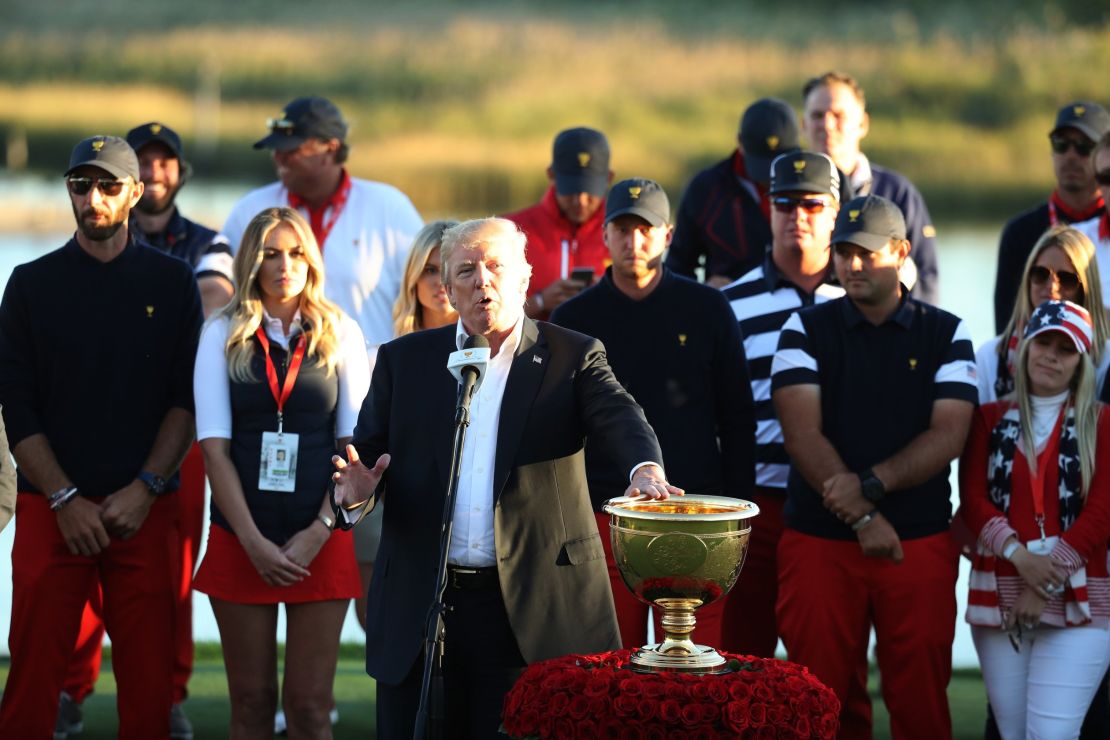 U.S. President Donald Trump presents the U.S. Team with the trophy after they defeated the International Team 19 to 11