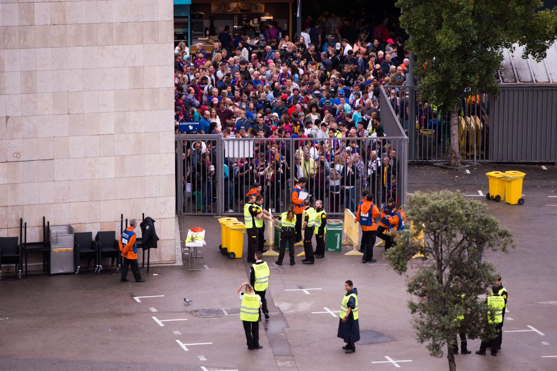 Spectators queued to access the Camp Nou stadium ahead of the match, which was ultimately played with empty stands after violence erupted at polling stations.