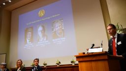 Secretary of the Nobel Committee for Physiology or Medicine, Thomas Perlmann (R), announces the winners of the 2017 Nobel Prize.