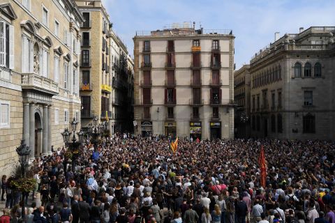 People attend a protest in Barcelona on Monday, October 2, a day after hundreds were injured in a police crackdown during the banned referendum. The Catalan government claimed victory after pushing forward with the vote despite Spain's Constitutional Court declaring it illegal.