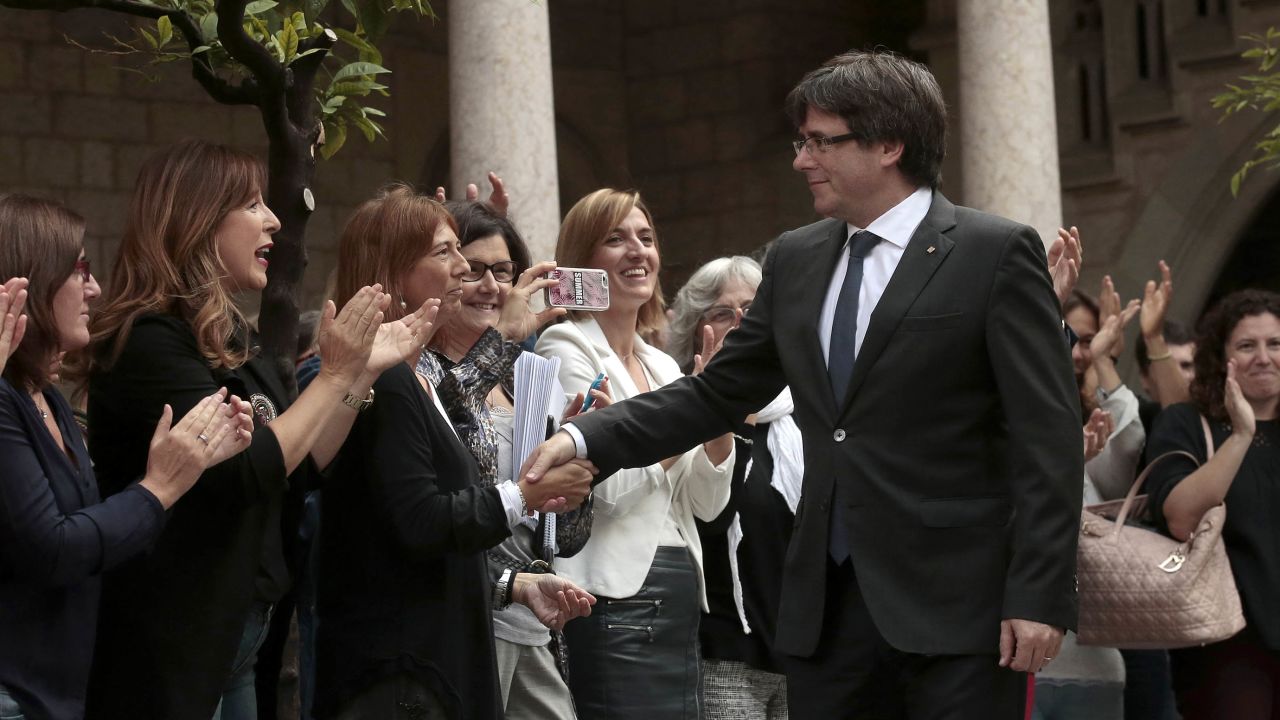Catalan President Carles Puigdemont shakes hands with workers of the Government of Catalonia before a government meeting at the Palau Generalitat in Barcelona, Spain, Monday, Oct. 2, 2017. Catalonia's government will hold a closed-door Cabinet meeting Monday to discuss the next steps in its plan to declare independence from Spain following a disputed referendum marred by violence. (AP Photo/Manu Fernandez)