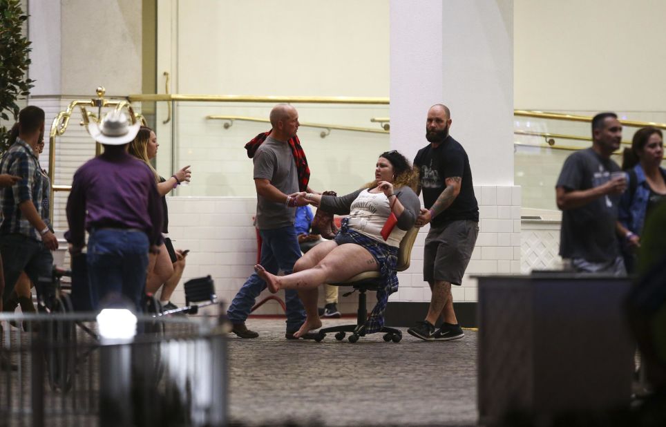 A woman is moved outside the Las Vegas Tropicana resort. Multiple victims were being transported to hospitals in the aftermath of the shooting. 