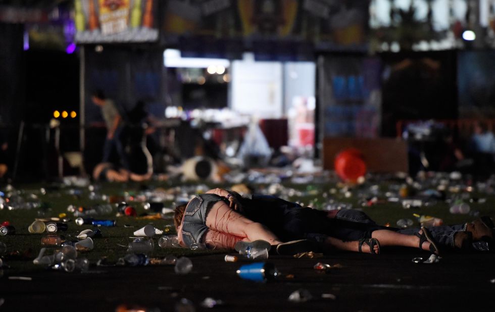 People are seen on the ground after the gunman opened fire.