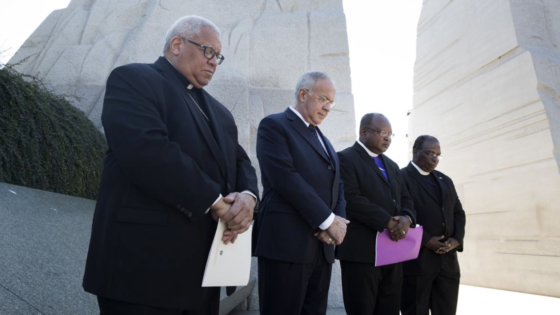 A moment of silence is held at the Martin Luther King Jr. Memorial in Washington during an event honoring the 60th anniversary of King's essay, "Nonviolence and Racial Justice."