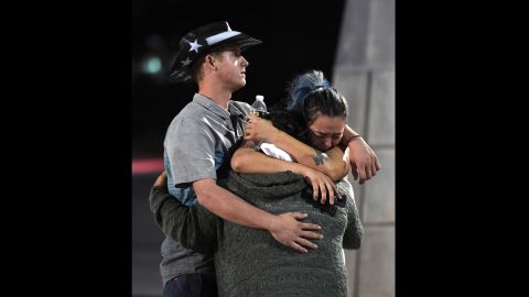 People embrace outside the Thomas & Mack Center after the shooting. 