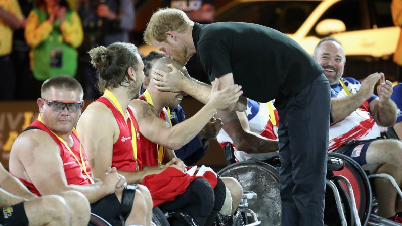 Britain's Prince Harry plants a kiss on Danish athlete Maurice Manuel after presenting him with a gold medal at the Invictus Games in Toronto on Thursday, September 28. Manuel is the captain of Denmark's wheelchair rugby team.