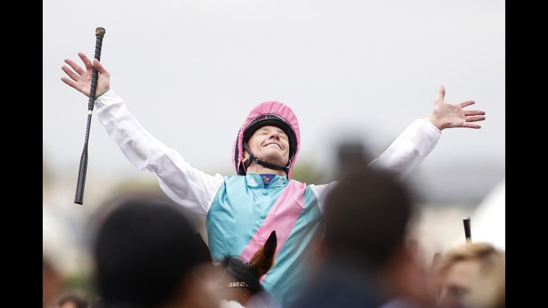 Jockey Frankie Dettori celebrates Sunday, October 1, after riding Enable<a href="index.php?page=&url=http%3A%2F%2Fwww.cnn.com%2F2017%2F10%2F01%2Fsport%2Fprix-de-larc-de-triomphe-dettori-enable%2Findex.html" target="_blank"> to win the Prix de l'Arc de Triomphe,</a> a horse race in Chantilly, France. He won the race for a record fifth time.