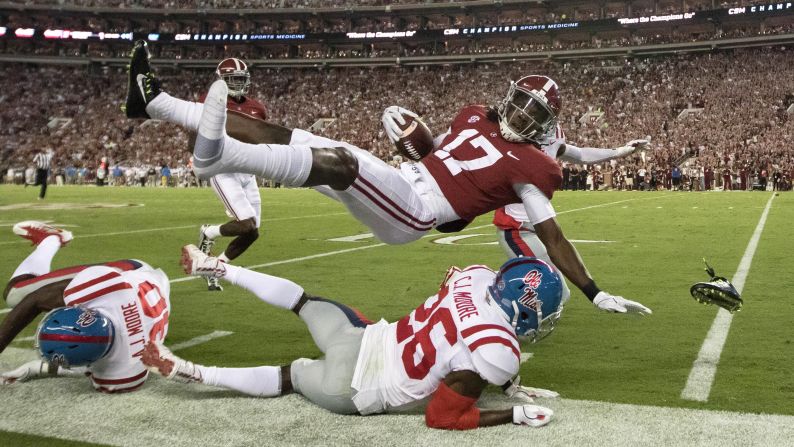 Alabama wide receiver Cam Sims goes flying -- and loses a shoe -- after being knocked out of bounds by Mississippi defensive back C.J. Moore on Saturday, September 30.