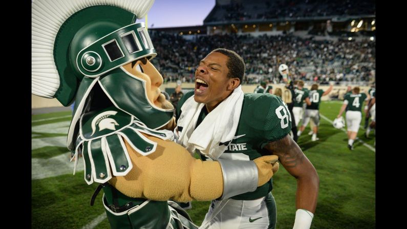 Michigan State wide receiver Trishton Jackson celebrates with Sparty the mascot after a 17-10 home victory over Iowa on Saturday, September 30.