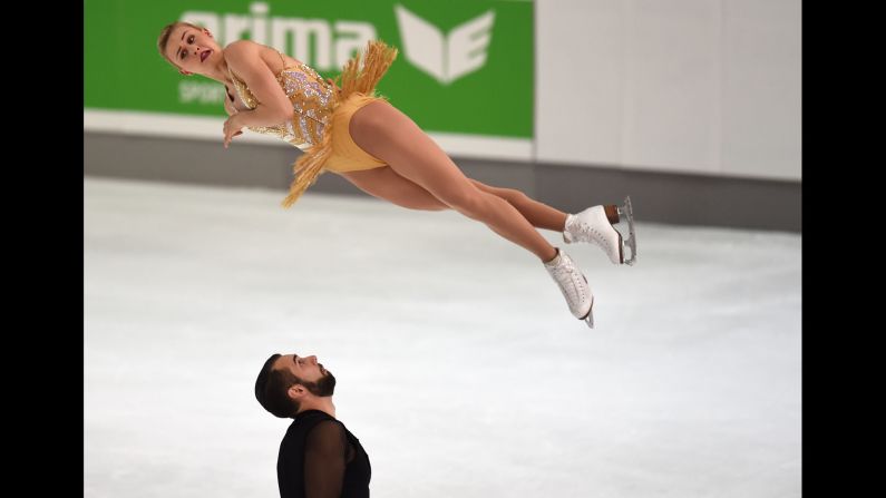 Figure skater Ashley Cain twists in the air Friday, September 29, as she and Timothy Leduc perform during the Nebelhorn Trophy competition in Oberstdorf, Germany.
