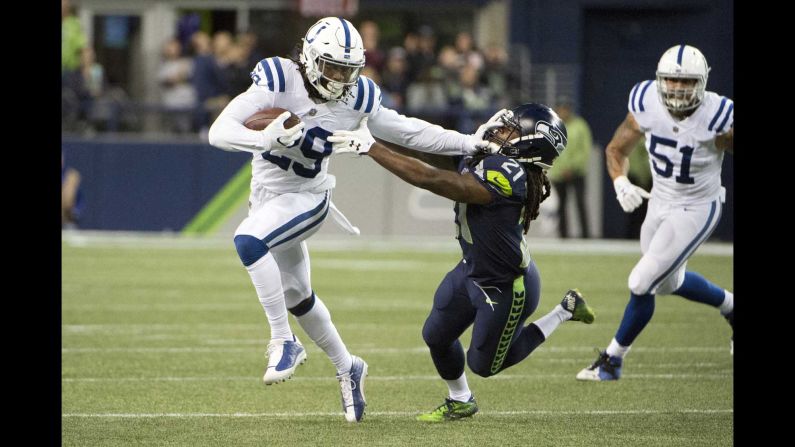 Indianapolis safety Malik Hooker stiff-arms Seattle running back J.D. McKissic after intercepting the ball on Sunday, October 1. It was his third interception of the season, which is tied for the NFL lead.