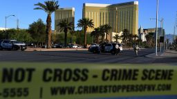 Crime scene tape surrounds the Mandalay Hotel (background) after a gunman killed at least 50 people and wounded more than 200 others when he opened fire on a country music concert in Las Vegas, Nevada on October 2, 2017. Police said the gunman, a 64-year-old local resident named as Stephen Paddock, had been killed after a SWAT team responded to reports of multiple gunfire from the 32nd floor of the Mandalay Bay, a hotel-casino next to the concert venue. / AFP PHOTO / Mark RALSTON        (Photo credit should read MARK RALSTON/AFP/Getty Images)