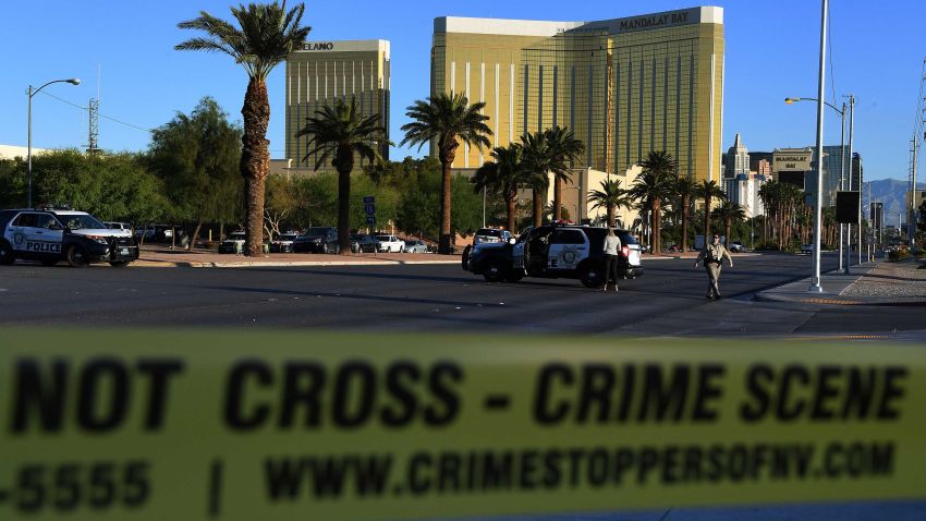 Crime scene tape surrounds the Mandalay Hotel (background) after a gunman killed at least 50 people and wounded more than 200 others when he opened fire on a country music concert in Las Vegas, Nevada on October 2, 2017. 
Police said the gunman, a 64-year-old local resident named as Stephen Paddock, had been killed after a SWAT team responded to reports of multiple gunfire from the 32nd floor of the Mandalay Bay, a hotel-casino next to the concert venue. / AFP PHOTO / Mark RALSTON        (Photo credit should read MARK RALSTON/AFP/Getty Images)