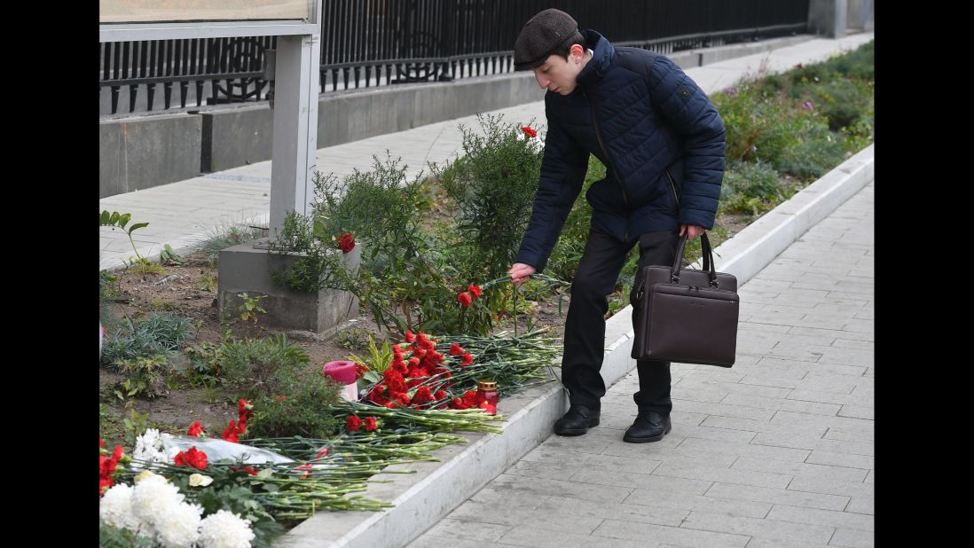 A man leaves flowers outside the US Embassy in Moscow on October 3.