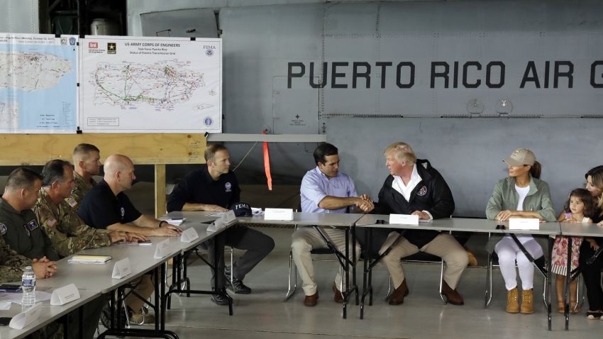 President Donald Trump shakes hands with Puerto Rico Gov. Ricardo Rosselló after arriving with first lady Melania Trump at Luis Muniz Air National Guard Base to survey hurricane damage and recovery efforts, Tuesday, Oct. 3, 2017, in San Juan, Puerto Rico. (AP/Evan Vucci)