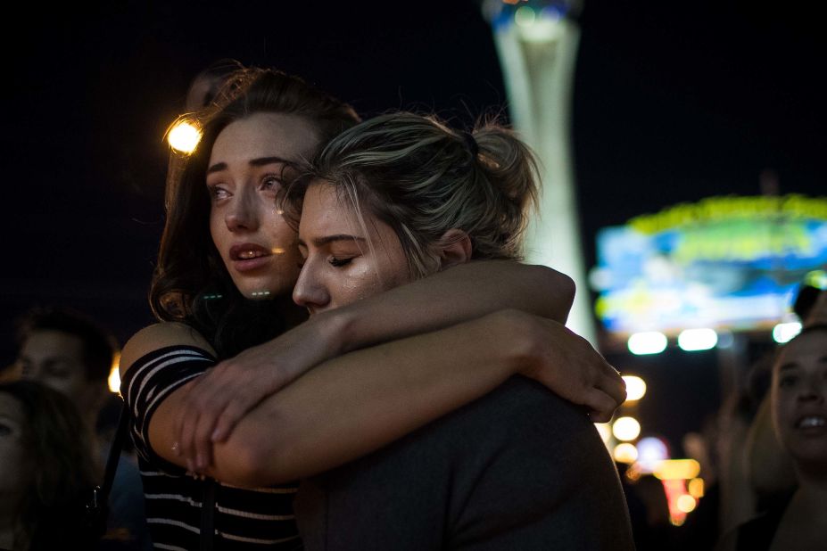 Mourners attend a vigil at the corner of Las Vegas Boulevard and Sahara Avenue on October 2.
