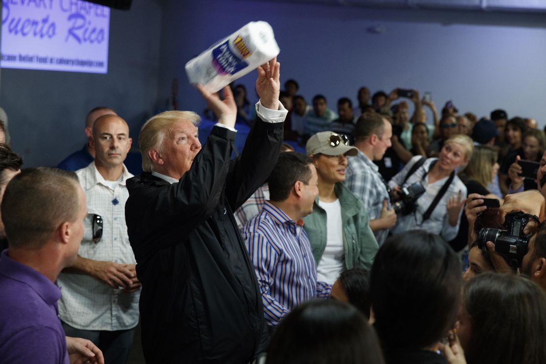 President Donald Trump tosses paper towels into a crowd at Calvary Chapel on October 3.