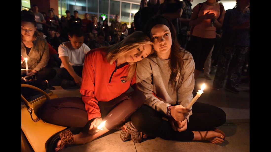 Lindsay Cotterman rests her head on Shawna Pieruschka's shoulder as they attend a candlelight vigil at the University of Nevada, Las Vegas on Monday, October 2.