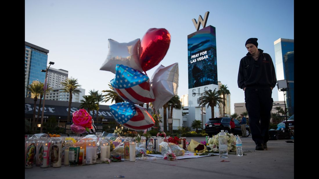Matthew Helms visits a makeshift memorial Tuesday, October 3, for the victims of <a href="http://www.cnn.com/2017/10/02/us/gallery/las-vegas-shooting/index.html" target="_blank">Sunday night's mass shooting in Las Vegas.</a> Helms worked as a medic during the shooting, which was the deadliest in modern US history.