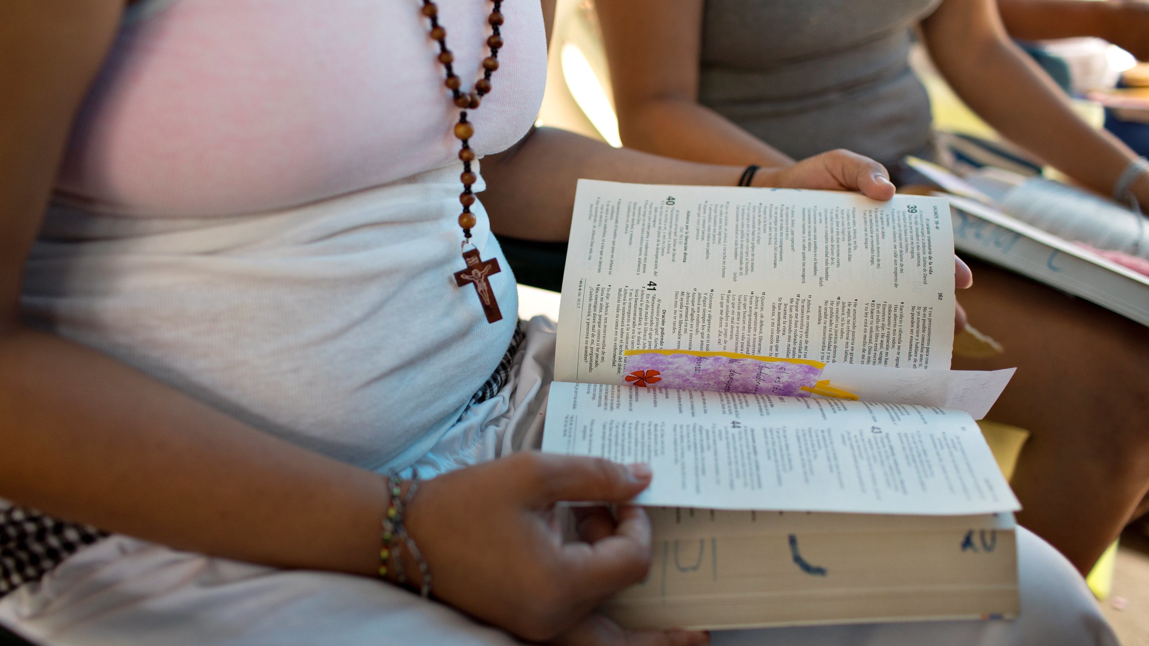 Women read from the Bible at El Salvador's Ilopango prison, which teaches inmates skills such as knitting, piata-making, painting, dancing, aerobics, reading, and cosmetology, among others.