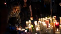 LAS VEGAS, NV - OCTOBER 2: Mourners light candles during a vigil at the corner of Sahara Avenue and Las Vegas Boulevard  for the victims of Sunday night's mass shooting, October 2, 2017 in Las Vegas, Nevada. Late Sunday night, a lone gunman killed more than 50 people and injured more than 500 people after he opened fire on a large crowd at the Route 91 Harvest Festival, a three-day country music festival. The massacre is one of the deadliest mass shooting events in U.S. history. (Photo by Drew Angerer/Getty Images)