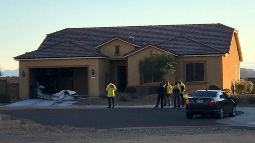 In this photo provided by the Mesquite, Nev., Police Department, police personnel stand outside the home of Stephen Paddock on Monday, Oct. 2, 2017, in Mesquite. Police identified Paddock as the gunman at a music festival Sunday evening. (Mesquite Police via AP)
