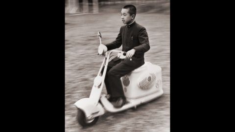 Akihito uses a scooter to whiz across the Imperial Palace grounds in 1948.