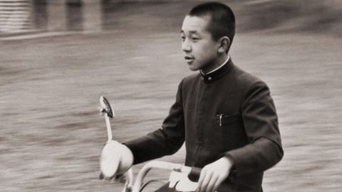 Akihito uses a scooter to whiz across the Imperial Palace grounds in 1948.