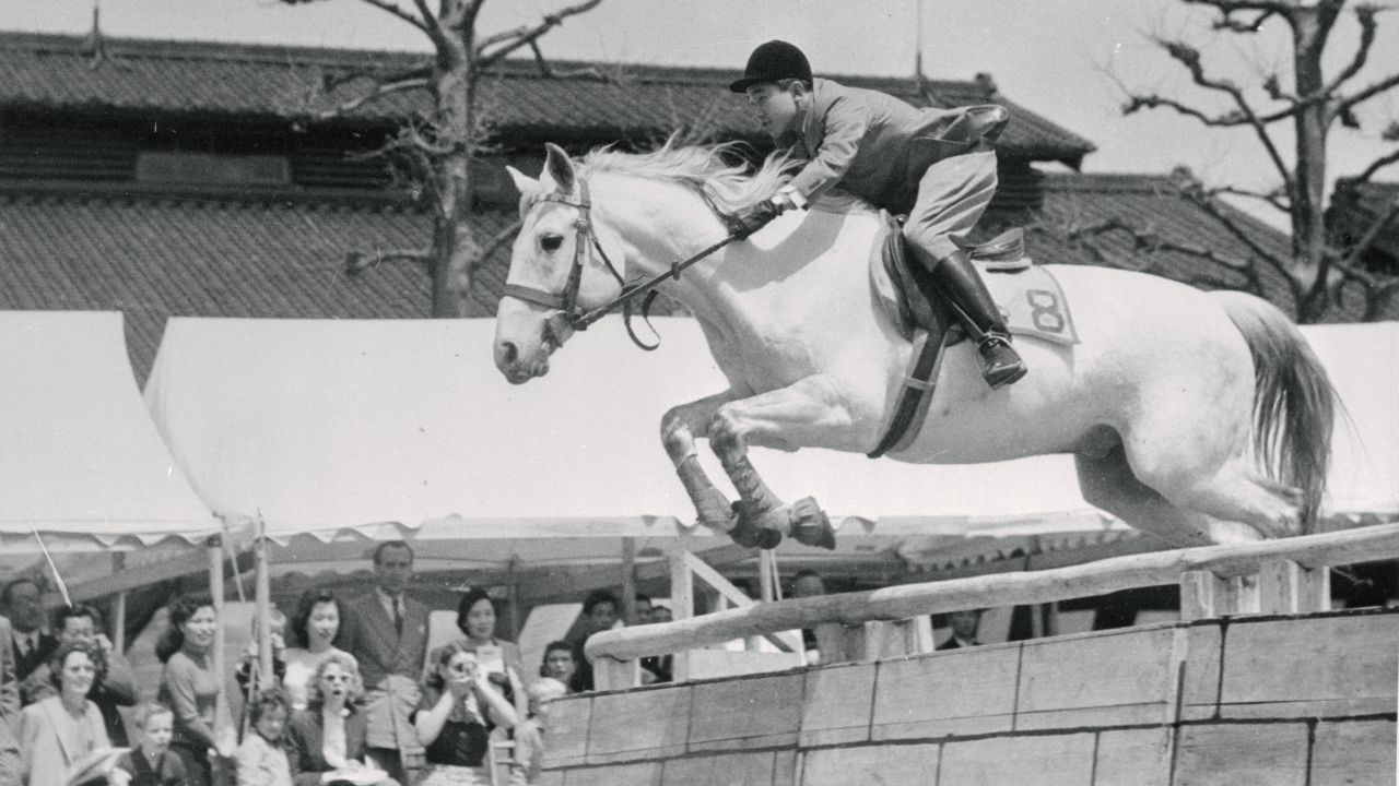 Akihito clears a hurdle during an equestrian event in Tokyo in 1952. It was staged as a send-off for Japanese Olympic riders.