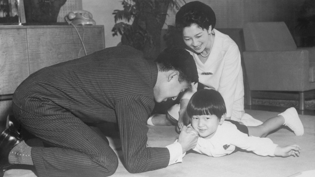 Akihito arm-wrestlers Naruhito while Michiko looks on. The couple had another son, Fumihito, in 1965. Their only daughter, Sayako, was born in 1969.