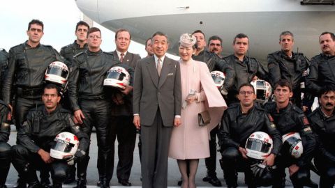 Akihito and Michiko pose with police officers who had escorted them at Brazil's Curitiba Airport in 1997.
