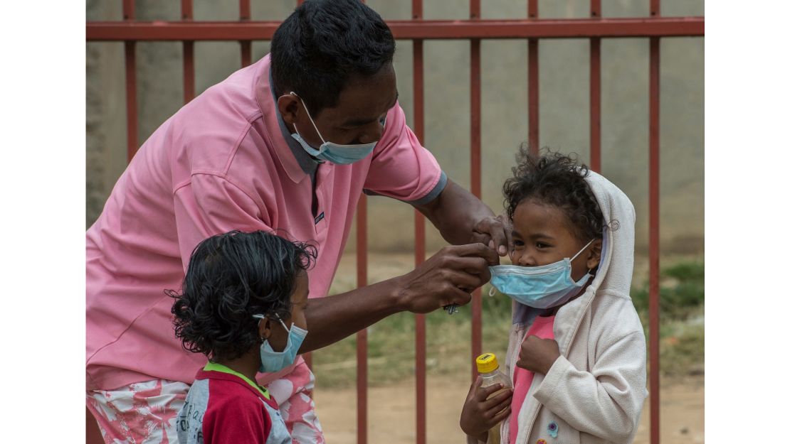 Face masks are placed on children in Antananarivo, Madagascar, as authorities struggle to contain an outbreak of plague that has killed dozens of people.