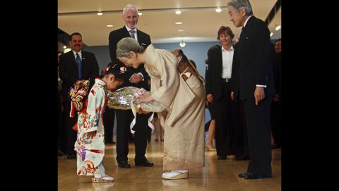Ayaka Tazumi, 5, presents flowers to Empress Michiko of Japan as she and Emperor Akihito prepare to leave the Japanese Canadian Cultural Center in Toronto on July 9, 2009.      