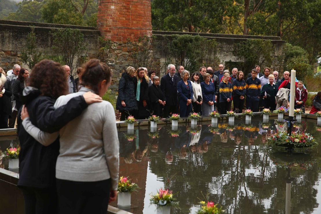 Family and community members lay 35 floral tributes at a memorial pool to Port Arthur victims during the 20th anniversary commemoration service in 2016. 