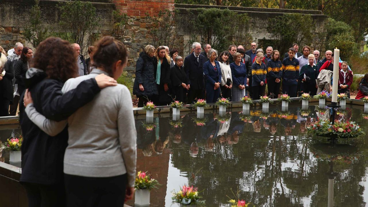 Family and community members lay 35 floral tributes at a memorial pool to Port Arthur victims during the 20th anniversary commemoration service in 2016. 