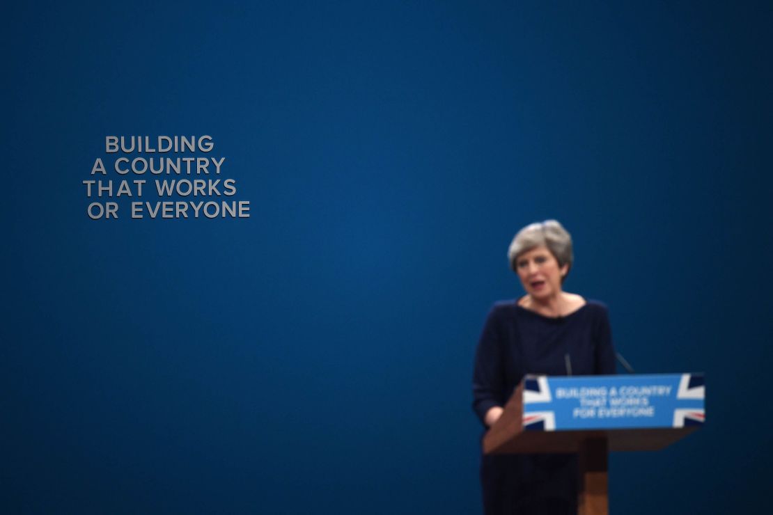  An 'F' falls off the backdrop as British Prime Minister Theresa May delivers her keynote speech.